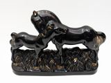 a statue of a horse and a dog on a field