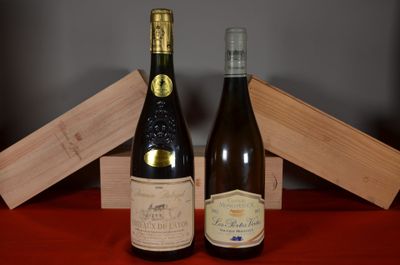 two bottles of wine sitting next to each other on a table