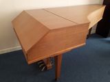 a wooden table with a wooden top on a blue carpeted floor