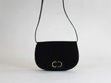 un sac à main noir orné d'un logo doré sur le devant
