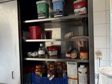 a large open cabinet in the middle of a kitchen