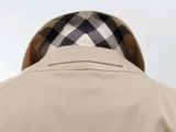 a close up of the back of a man ' s jacket with a checkered collar