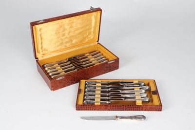 two knives and a knife holder in a box