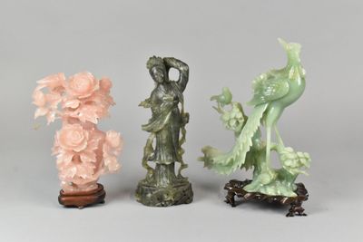three different colored figurines of birds and flowers on a table
