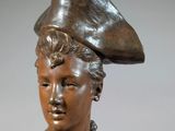 statue of a woman with a hat on her head