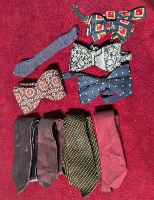 several different ties are laid out on a red surface
