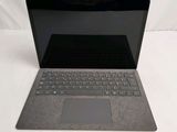 a laptop that is sitting on a white surface