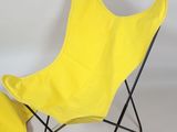 a yellow butterfly chair and a yellow foot stool
