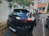 a black car parked in a parking lot next to a building