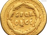 an image of a gold coin with a circular design on it