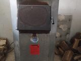 a small machine that is sitting in the middle of a pile of wood