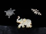 three pieces of jewelry including a turtle, an elephant and a turtle