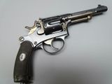 an old gun is sitting on a table on a white surface