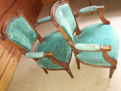 two green chairs sitting next to each other on the floor