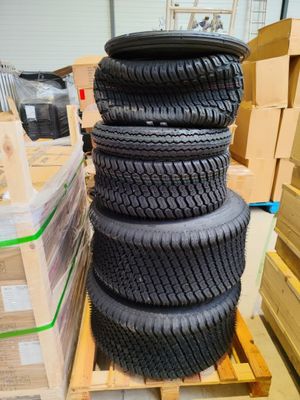 tires stacked up on pallets in a warehouse