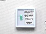 a picture of a green emerald in a white box