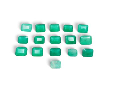 a group of emerald green rectangular cut stones on a white surface