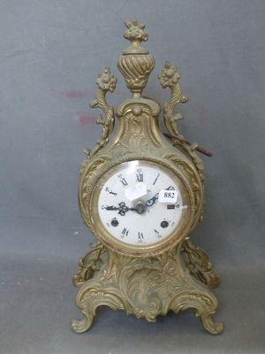 a gold clock that is sitting on a table