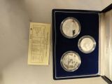 an image of a box with three silver coins in it