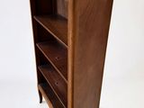 an image of a wooden bookcase with a shelf on top