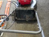 a lawn mower that is sitting on the ground