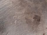 a silver plate with a number on it on a table