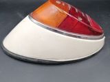 a close up of a red and white light on a black surface