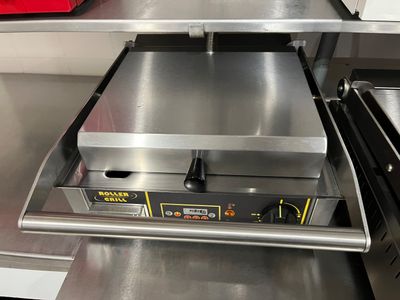 stainless steel counter top with an electric pizza oven on it