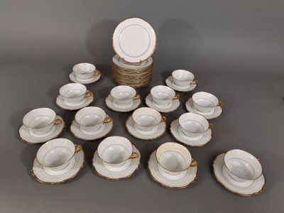 a lot of cups and saucers sitting on a table
