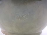 a close up of a vase with writing on it