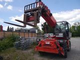 a red crane that is sitting in the middle of a parking lot