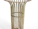 a metal basket that is sitting on a white surface