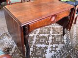 a small wooden table with a drawer on top of it