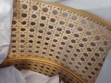 a wicker chair with a white sheet covering it
