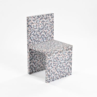 a chair made out of paper with a pattern on the back