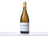 the bottle of white wine is sitting on the table