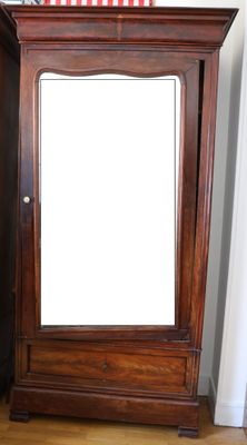 a tall wooden cabinet with a mirror on top of it