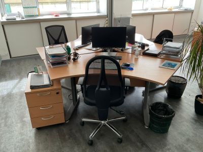 a desk with a chair and a computer on it