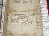 an old book with writing on it sitting on a table
