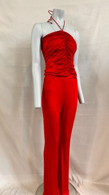 the mannequin is wearing a red jumpsuit and a white top