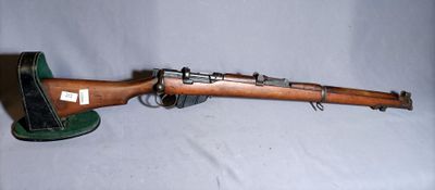 an old wooden rifle with a green hat on top of it