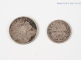 two coins that are sitting side by side on a white surface