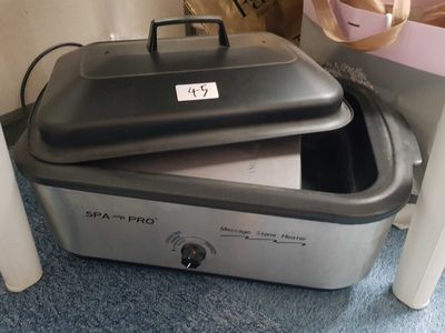 a crock pot sitting on top of a crock pot on the floor