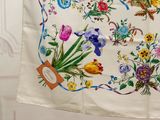 a white table cloth with a picture of flowers on it