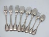 six silver plated forks and spoons are lined up on a white surface