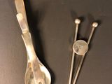 two spoons and a spoon rest on a table