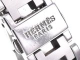 a close up of a watch on a white surface
