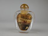 a glass bottle with a picture of a boat in it