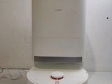 a white air purifier sitting on top of a white table