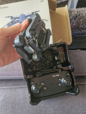 a person holding a remote control that is in a box